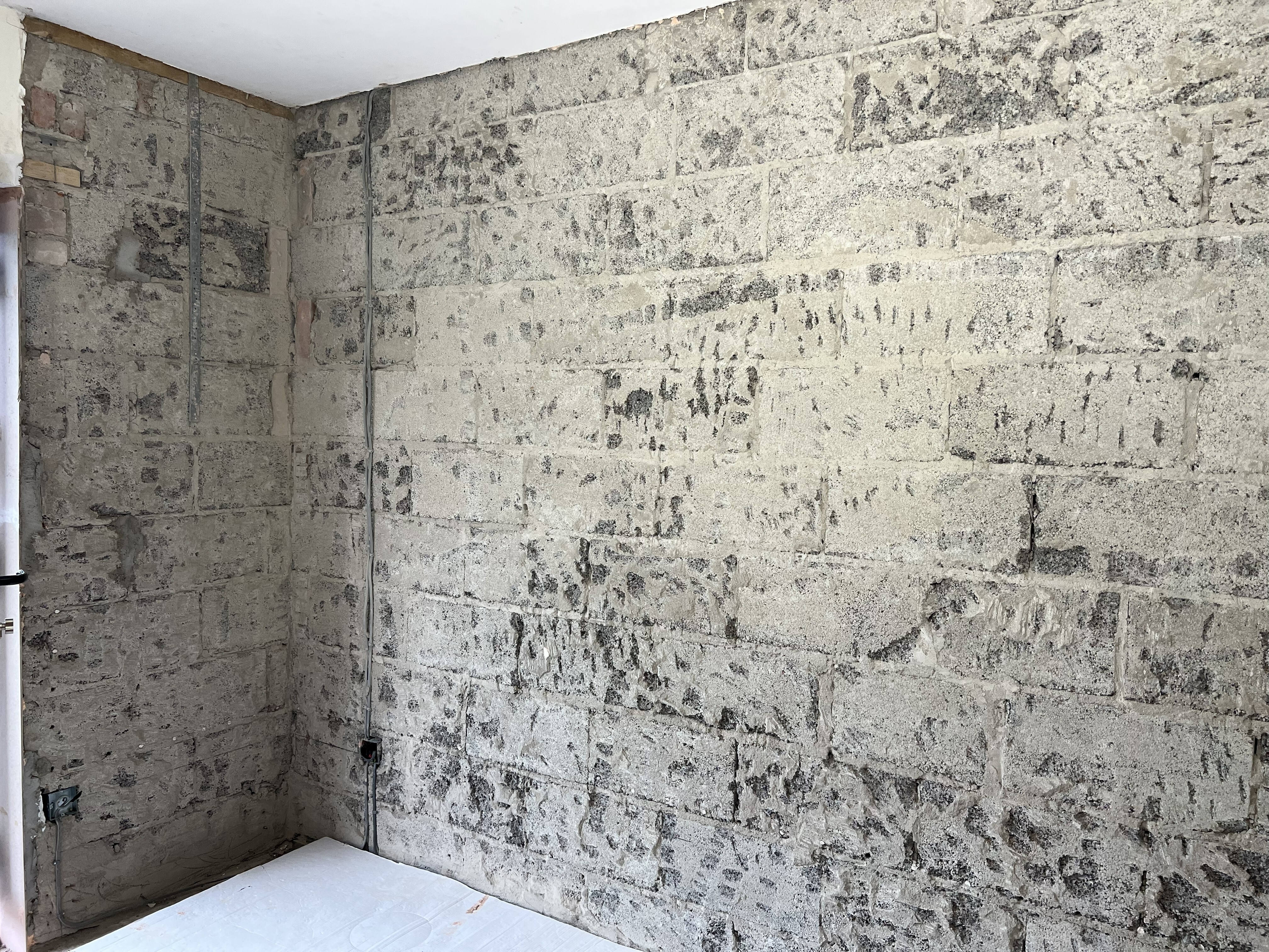 Prepping the surface Bare Wall, prepared ready for applying the Supertherm plaster, shows a bare concrete block wall
