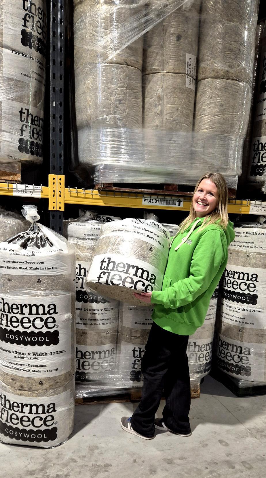Sarah holding Thermafleece Cosywool Insulation in the warehouse 2026