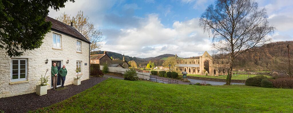 F and M at Tintern Abbey Cottage with abbey panorama