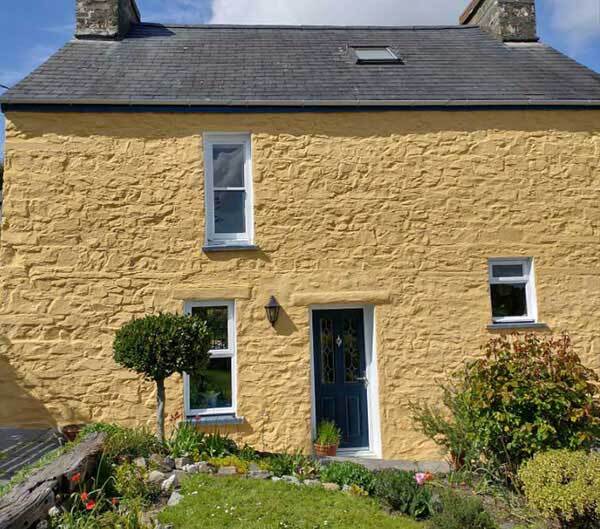 Yellow Ochre Limewash applied to traditional stone cottage